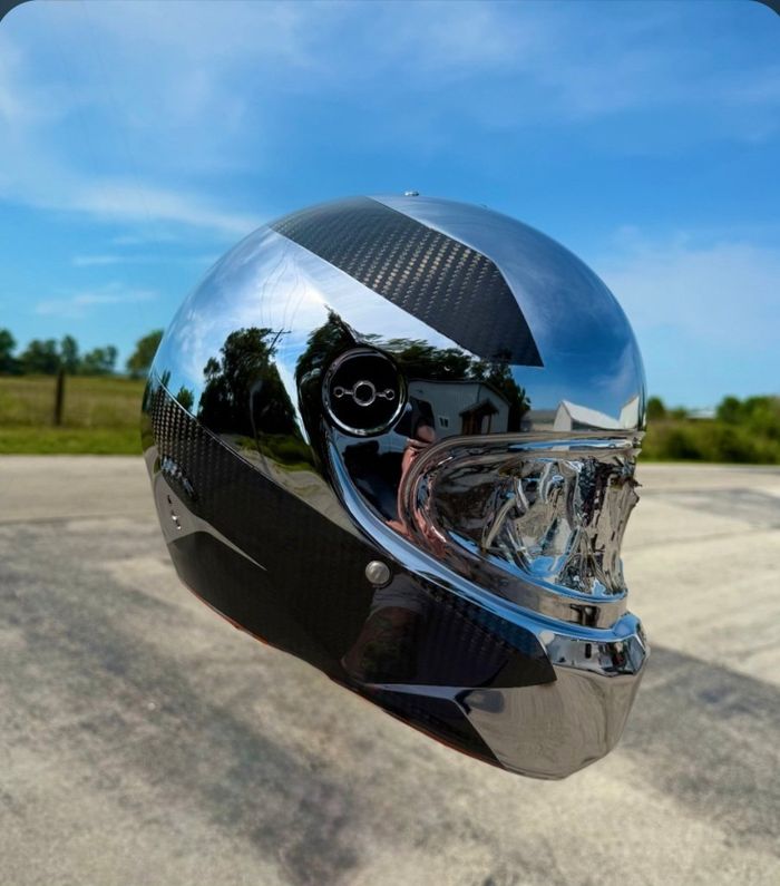Chrome and carbon PVD finished helmet against a blue sky