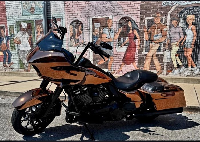 Copper PVD finished bagger parked in front of a mural